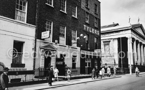 A pawn shop (The Three Balls) with the typical sign beside the St Marys Pro-Cathedral Marlborough Street. Tylers was a shoe shop chain. Dublin 1963. - Photo by Edward Quinn