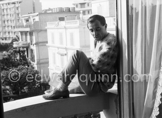 Charles Aznavour on the balcony of his room at the Carlton Hotel. Cannes Film Festival 1959. - Photo by Edward Quinn