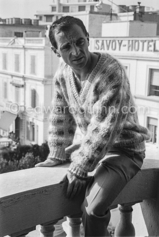 Charles Aznavour on the balcony of his room at the Carlton Hotel. Cannes Film Festival 1959. - Photo by Edward Quinn