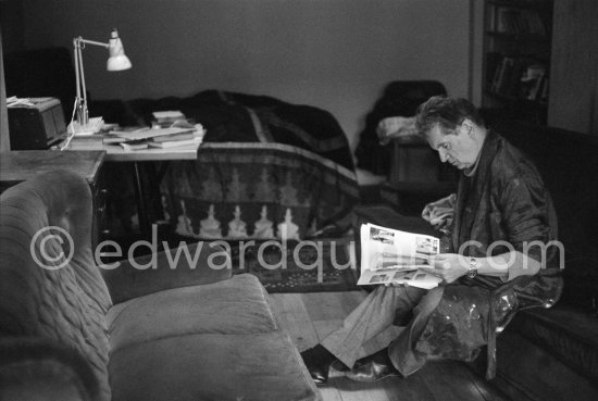 Francis Bacon viewing a mockup of a planned book on him at his Reece Mews home. London 1978. - Photo by Edward Quinn