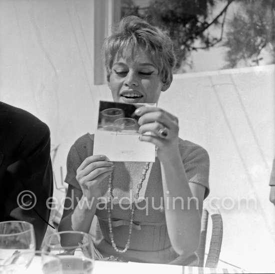 Brigitte Bardot with her Set Card. Cannes Film Festival 1956. - Photo by Edward Quinn