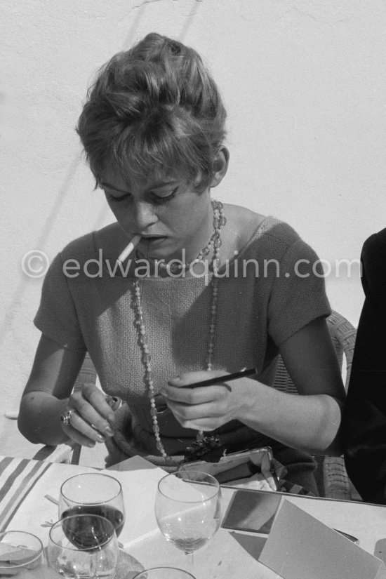 Brigitte Bardot signing autograph, Cannes Film Festival 1956. - Photo by Edward Quinn