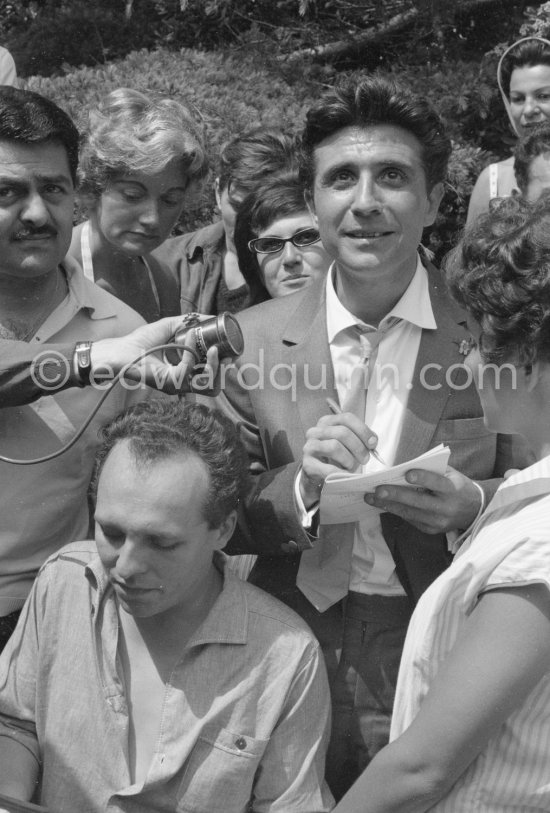 Gilbert Bécaud signing autographs. Cannes Film Festival 1960. - Photo by Edward Quinn