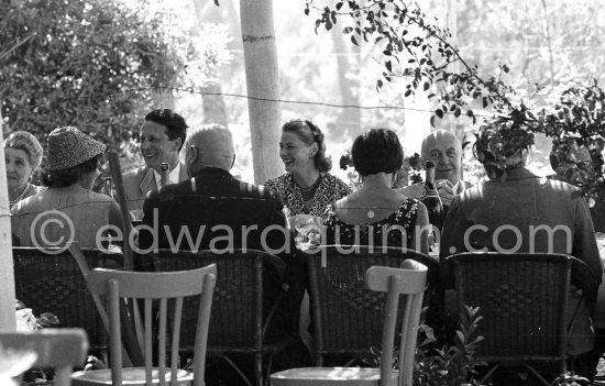Ingrid Bergman at lunch. On the left the Cannes Festival founder and president Robert Favre Le Bret, right film director Otto Preminger. Cannes 1956. - Photo by Edward Quinn