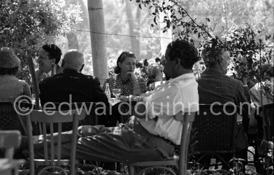 Ingrid Bergman pensively at lunch. On the left the Cannes Festival founder and president Robert Favre Le Bret. Cannes 1956. - Photo by Edward Quinn