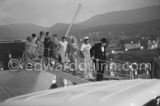 On several occasions Sir Winston Churchill was a guest on Onassis\' yacht Christina anchored in the harbor of Monaco. Behind a sailor is Lady Churchill. Monaco 1959. - Photo by Edward Quinn