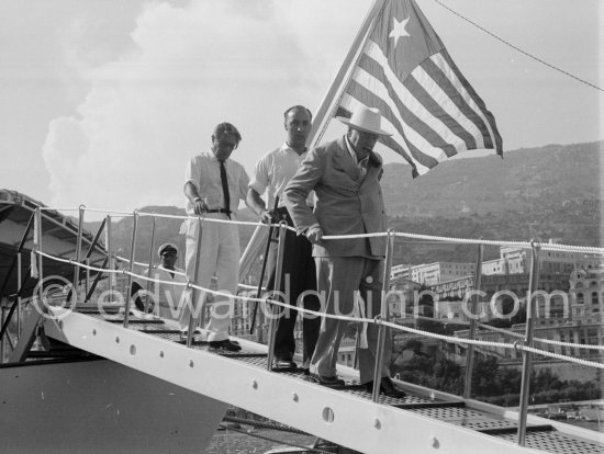 Onassis and Sir Winston Churchill leaving Onassis\' yacht Christina. Monaco harbor 1959. - Photo by Edward Quinn