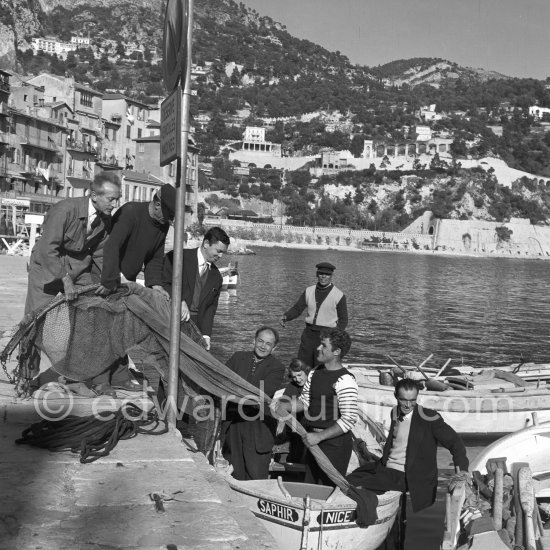 Jean Cocteau with fishermen at the time when he was working on his mural in the Chapelle Saint Pierre. Villefranche-sur-Mer 1956. - Photo by Edward Quinn
