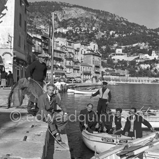 Jean Cocteau with fishermen at the time when he was working on his mural in the Chapelle Saint Pierre. Villefranche-sur-Mer 1956. - Photo by Edward Quinn