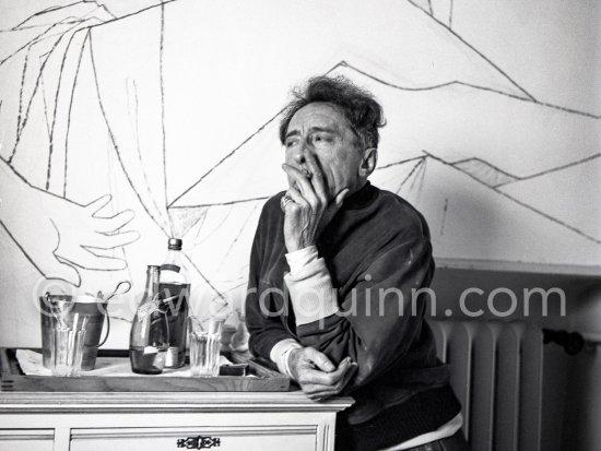 Jean Cocteau at Villa Santo Sospir of his close friend Francine Weisweiller in front of one of the murals he made for the interior walls. With two Cartier Trinity rings. Saint-Jean-Cap-Ferrat 1954. - Photo by Edward Quinn