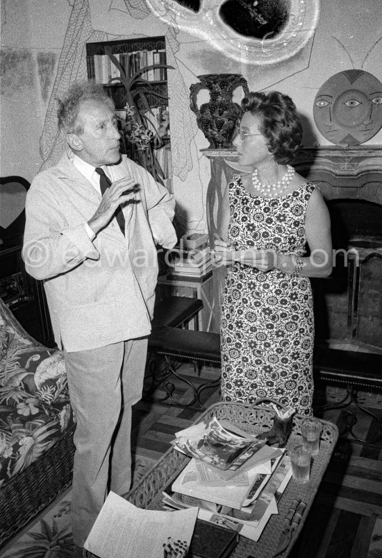 Jean Cocteau at Villa Santo Sospir with a local journalist. On the table photos by Edward Quinn. Saint-Jean-Cap-Ferrat 1959. - Photo by Edward Quinn