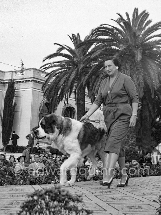 Charming, friendly, and remarkable: Lady with St. Bernard. Concours d’élégance, Cannes 1953. - Photo by Edward Quinn