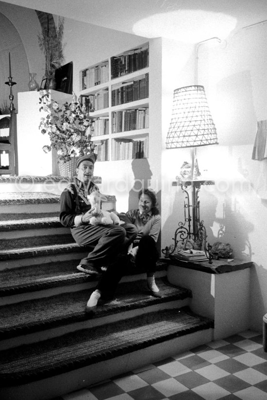 Salvador Dalí with a stuffed toy lamb and his Russian-born wife Gala. Salvador Dalí was known to submit all his work for Gala’s approval. At Salvador Dalí’s house, Portlligat, Cadaqués,1957. - Photo by Edward Quinn
