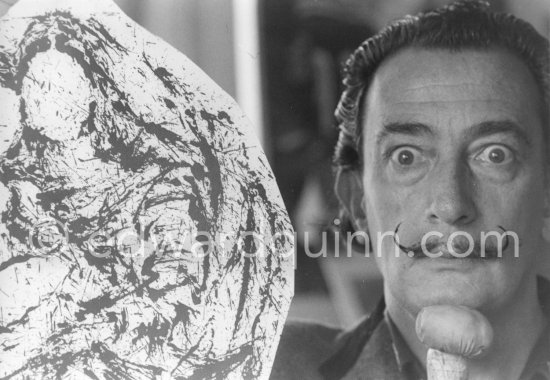 Dalí poses at his studio with his ink drawing of a madonna and her child and the painting "Cosmic Madonna", finished in 1958. At Salvador Dalí\'s house, Portlligat, Cadaqués, 1957. - Photo by Edward Quinn