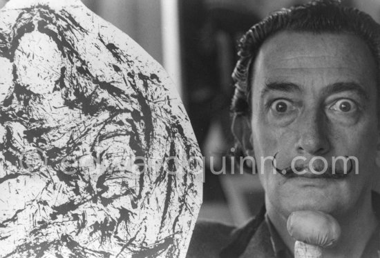 Salvador Dalí poses at his studio with his ink drawing of a Madonna and her child and the painting "Cosmic Madonna", finished in 1958. At Salvador Dalí\'s house, Portlligat, Cadaqués, 1957. - Photo by Edward Quinn