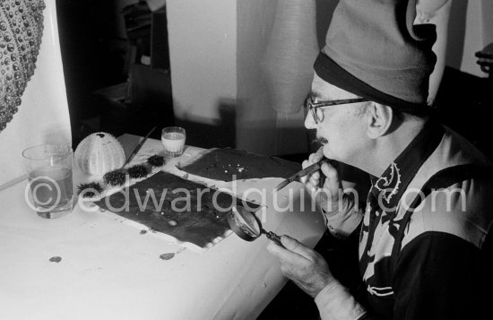 Salvador Dalí demonstrates the origin of the "oursin", a liquid which takes on a particular form. Here he is seen using milk and water. At Salvador Dalí\'s house, Portlligat, Cadaqués 1957. - Photo by Edward Quinn