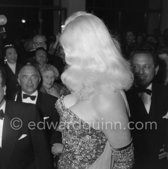 Many pairs of admiring eyes looking at the voluminous blond hair of Diana Dors. Cannes Film Festival 1956. - Photo by Edward Quinn