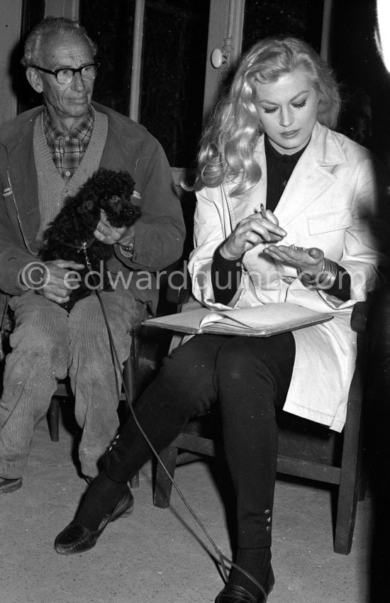 Swedish actress Anita Ekberg buying two poodles at a kennel. Nice 1960. - Photo by Edward Quinn
