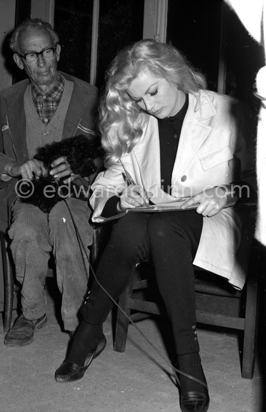 Swedish actress Anita Ekberg buying two Tiny Poodles at a kennel. Nice 1960. - Photo by Edward Quinn
