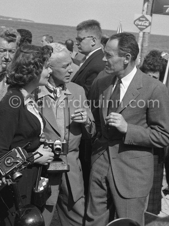 Henry Fonda talking to the Russian actress Izolda Izwitzkaja, known as the Russian Marilyn Monroe, and another Russian actor at La Napoule. Cannes Film Festival 1957. - Photo by Edward Quinn