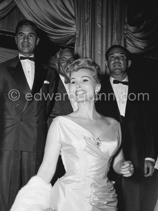 Zsa Zsa Gabor at the Red Cross Gala in the club Sporting d\'Eté in Monte Carlo in 1955. Porfirio Rubirosa in the background. - Photo by Edward Quinn