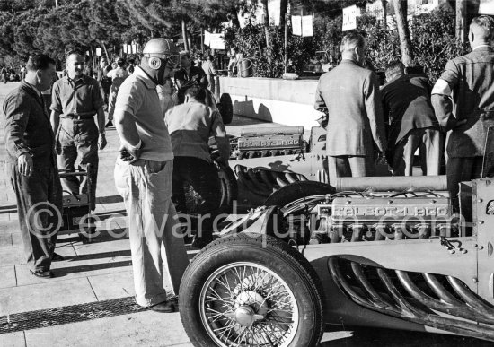 Alfredo Pian interested in the two Talbot Lago T26. He was on Maserati 4CLT. On the second day of the training he had an accident, was flung from his car and fractured his right fibula.   Monaco Grand Prix 1950. - Photo by Edward Quinn