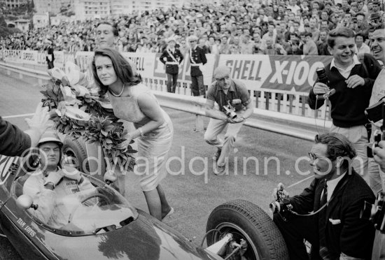 An American film company making the film "Love is a Ball" took advantage of the race to shoot some scenes during practice. Here French actress Béatrice Altariba is with actor Glenn Ford who plays a retired racing driver, in the cockpit of Trevor Taylor\'s Lotus-Climax. Monaco Grand Prix 1962. - Photo by Edward Quinn