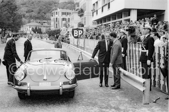 Prince Rainier with Princess Grace after their circuit-opening tour of honour with their Porsche 911. (The cars of the Prince had the number plates **77). Monaco Grand Prix 1962. - Photo by Edward Quinn