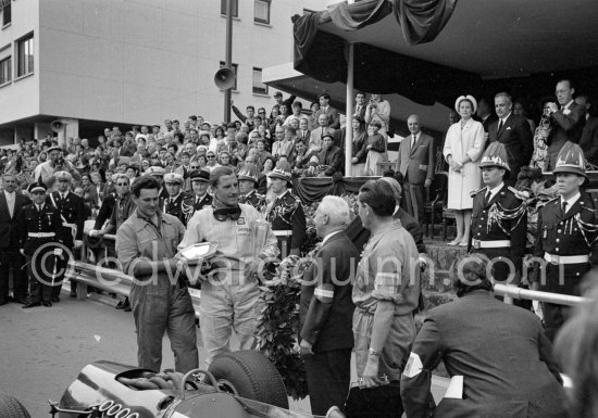 Race winner Graham Hill, (3) BRM P261. On the podium with Princess Grace and Prince Rainier of Monaco. Monaco Grand Prix 1965. - Photo by Edward Quinn