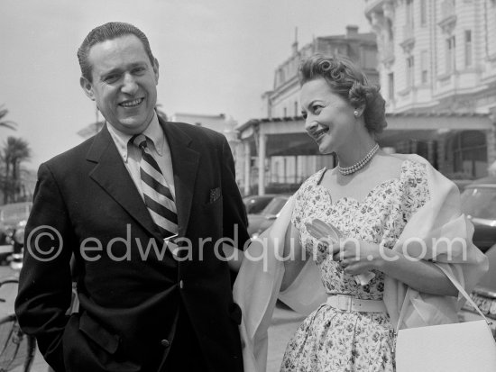 Olivia de Havilland and husband Pierre Galante, journalist of Paris Match. He was responsible for the first meeting of Grace Kelly and Prince Rainier of Monaco in May 1955. In front of Carlton Hotel, Cannes 1954. - Photo by Edward Quinn