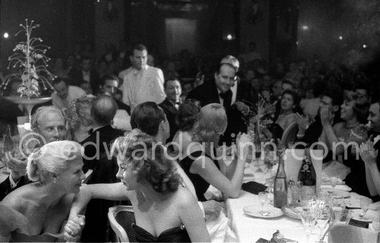 Susan Hayward and Ginger Rogers in animated conversation during the closing gala dinner at Cannes Film Festival 1956. - Photo by Edward Quinn