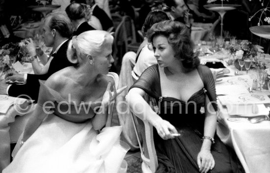 Susan Hayward and Ginger Rogers in animated conversation during the closing gala dinner at Cannes Film Festival 1956. - Photo by Edward Quinn