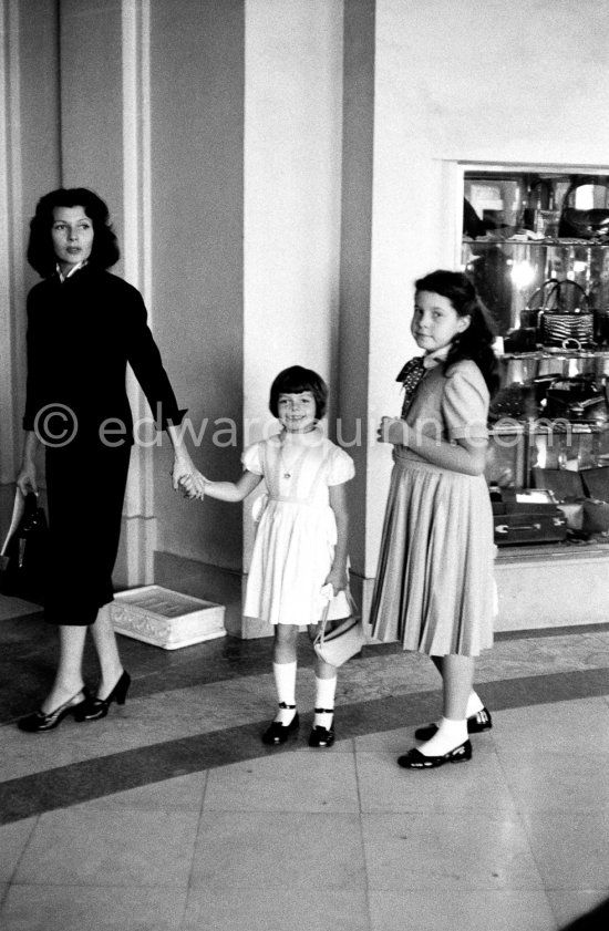 Rita Hayworth with her daughters Rebecca (daughter of Rita Hayworth and Orson Welles) and Yasmina (right) in front of the Hotel Negresco in Nice in 1955. - Photo by Edward Quinn