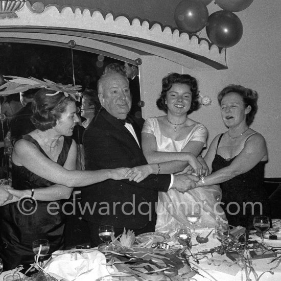 Alfred Hitchcock, his wife and his daughter (right) and a friend. New Year Eve Gala Evening, Hotel Badrutt\'s Palace, St. Moritz 1961. - Photo by Edward Quinn
