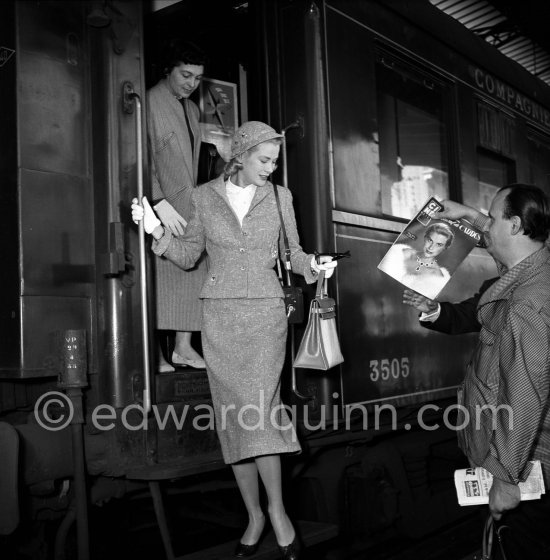 Grace Kelly arriving at Cannes station 1955 with the original Kelly Bag and her Rolleiflex camera. With her is her friend Gladys de Ségonzac, costume designer, who had helped her with the wardrobe on "To catch a thief". - Photo by Edward Quinn
