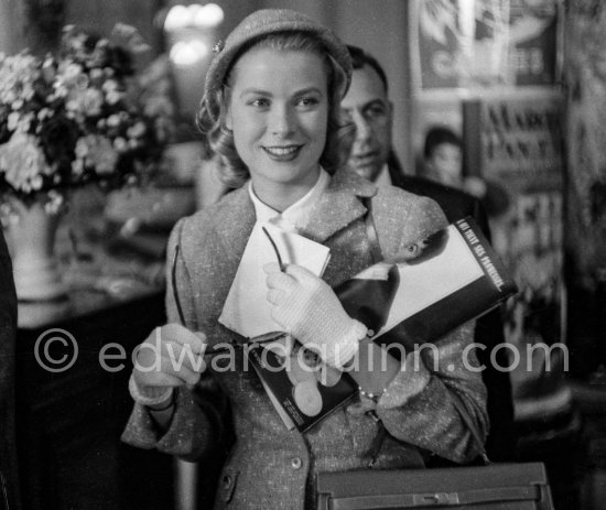 Grace Kelly with the original Kelly Bag arriving at Cannes station 1955. - Photo by Edward Quinn