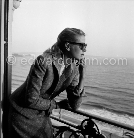 Grace Kelly on the balcony of her room in the Carlton Hotel. Cannes Film Festival 1955. - Photo by Edward Quinn