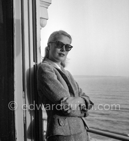 Grace Kelly on the balcony of her room in the Carlton Hotel. Cannes Film Festival 1955. - Photo by Edward Quinn