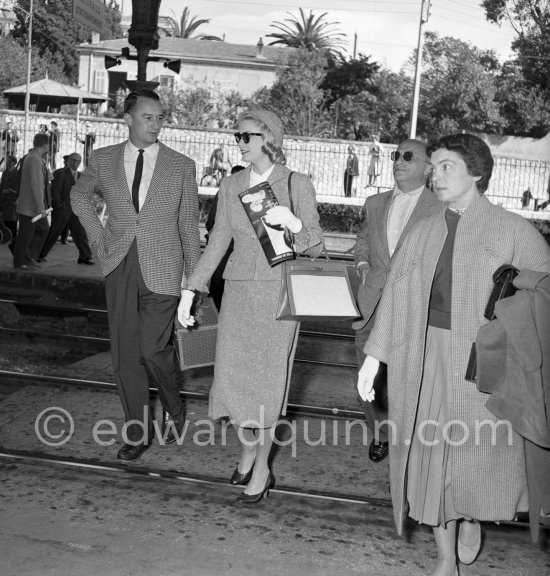 Grace Kelly arriving at Cannes station 1955 with the original Kelly Bag. With her is her friend Gladys de Ségonzac (right), costume designer, who had helped her with the wardrobe on "To catch a thief" and Rupert Allan. - Photo by Edward Quinn