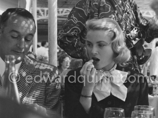 A cup of coffee for Grace Kelly at the Cannes Film Festival. On the left Rupert Allan. Cannes 1955. Trinity ring by Cartier - Photo by Edward Quinn