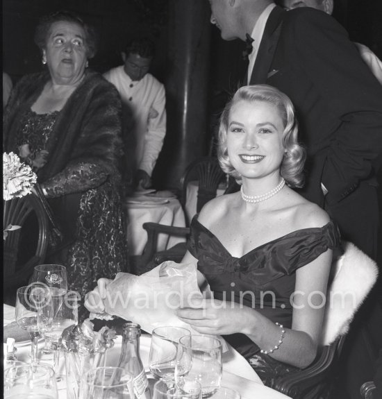 Grace Kelly. Elsa Maxwell, American gossip journalist in the background. Cannes Film Festival 1955. - Photo by Edward Quinn