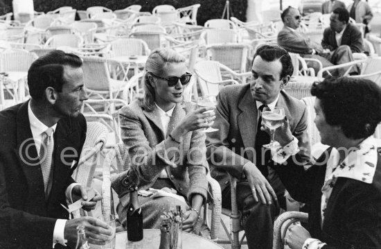 Grace Kelly, Gordon White (left), chairman of Hanson Industries and Gladys de Ségonzac (right), costume designer, on the terrasse of the Carlton Hotel. Cannes Film Festival 1955. - Photo by Edward Quinn