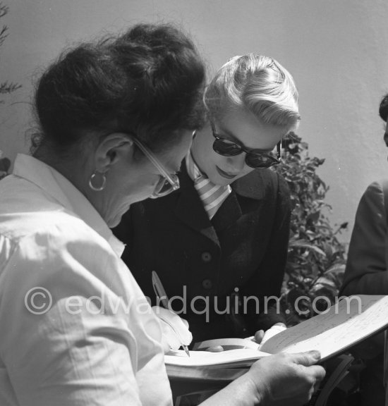 Grace Kelly signing autographs. Cannes Film Festival 1955. - Photo by Edward Quinn