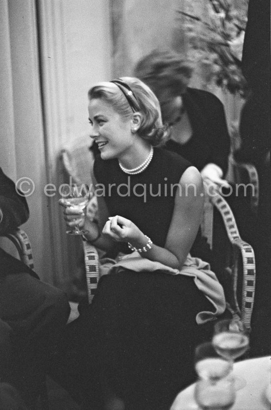 Grace Kelly during a press cocktail party at the Carlton Hotel, where she charmed everybody by trying out her French and emphasizing her words with gestures and expressions. Cannes 1954. - Photo by Edward Quinn