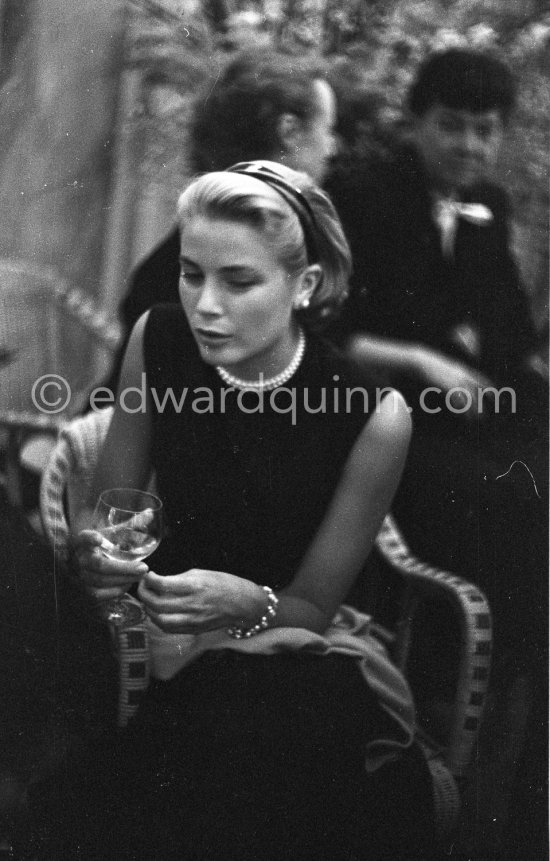 Grace Kelly during a press cocktail party at the Carlton Hotel, where she charmed everybody by trying out her French and emphasizing her words with gestures and expressions. Cannes 1954. - Photo by Edward Quinn