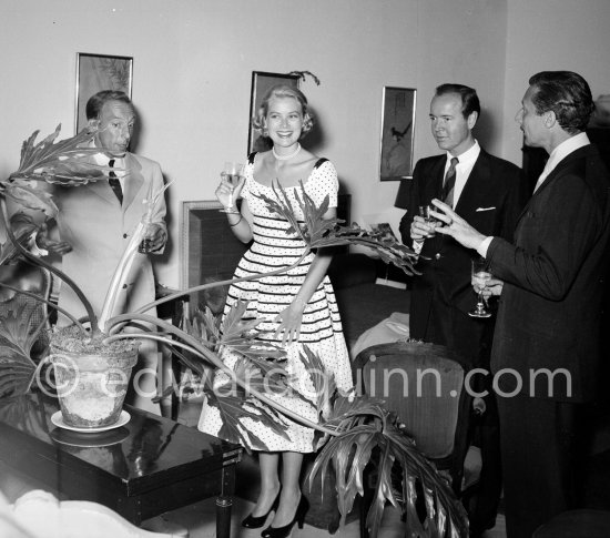 Grace Kelly at a cocktail party given by Jacques Fath (left) at his home "Moulin de Joko". On the right celebrity promoter Earl Blackwell and American fashion designer Oleg Cassini. Cannes 1954. - Photo by Edward Quinn