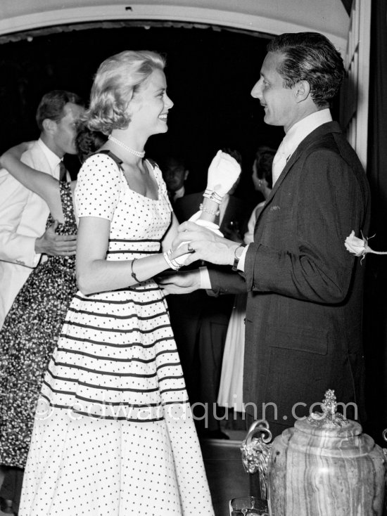 A love affair: Grace Kelly with American fashion designer Oleg Cassini at a cocktail party given by Jacques Fath at his home "Moulin de Joko". Cannes 1954. - Photo by Edward Quinn