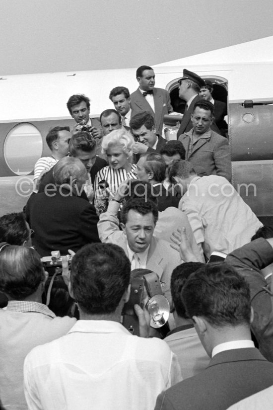 When Jayne Mansfield came to the Cannes Film Festival in 1958, she had just married Mickey Hargitay, the ex-muscle man in Mae West’s nightclub act and former Mr. Universe. From the moment of her arrival at Nice Airport, Jayne had to fight her way through a crowd of fans and journalists. Nice Airport 1958. - Photo by Edward Quinn