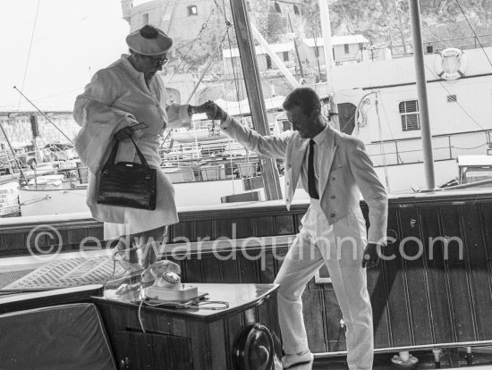 American gossip columnist Elsa Maxwell getting on board Onassis\' yacht Christina. Monaco harbor 1956. - Photo by Edward Quinn