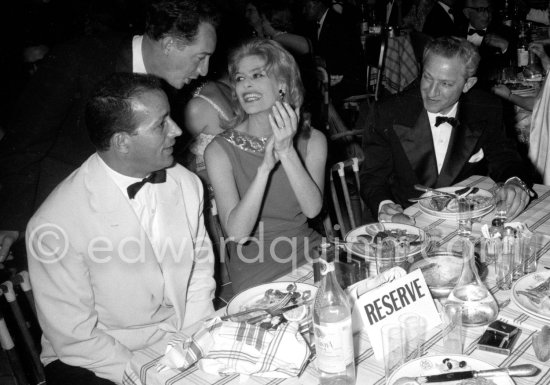 From left Giorgos Fondas, Melina Mercouri and her husband, director Jules Dassin. For "Never on Sunday". Les Ambassadeurs, Cannes 1960. - Photo by Edward Quinn